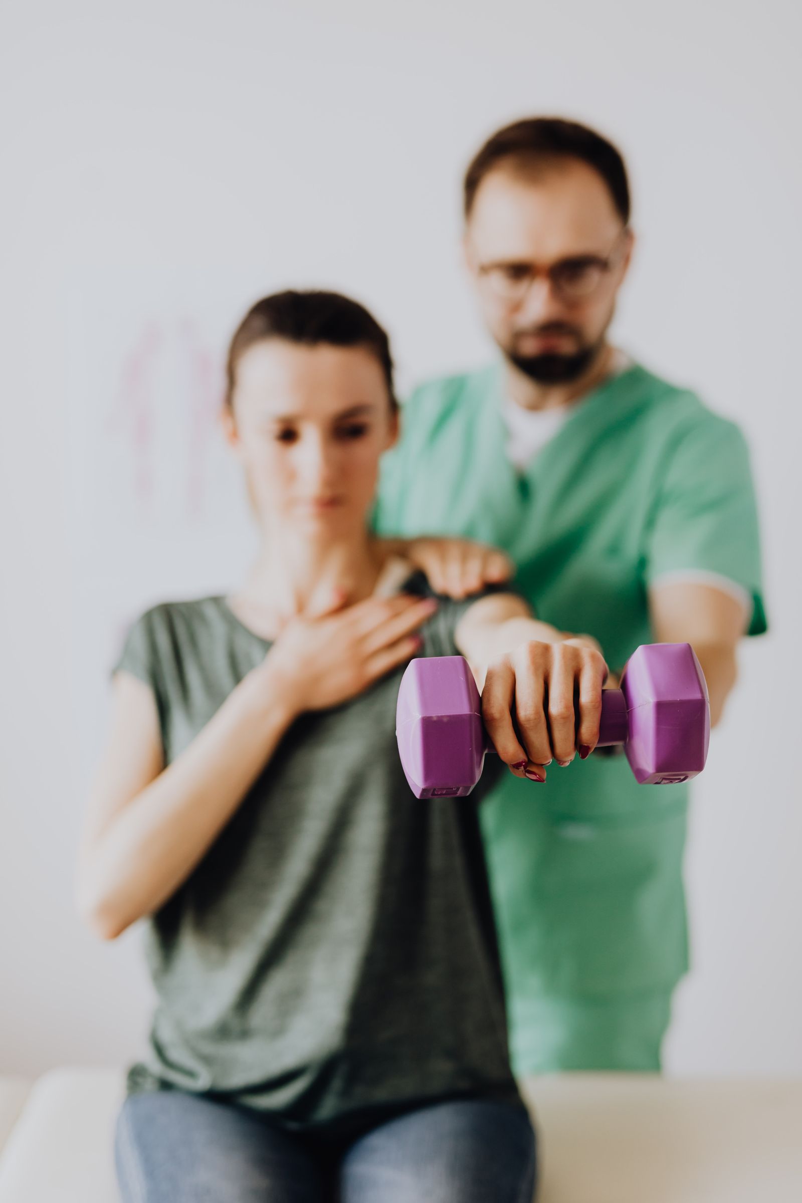 Physiotherapist assisting a patient during a rehabilitation session