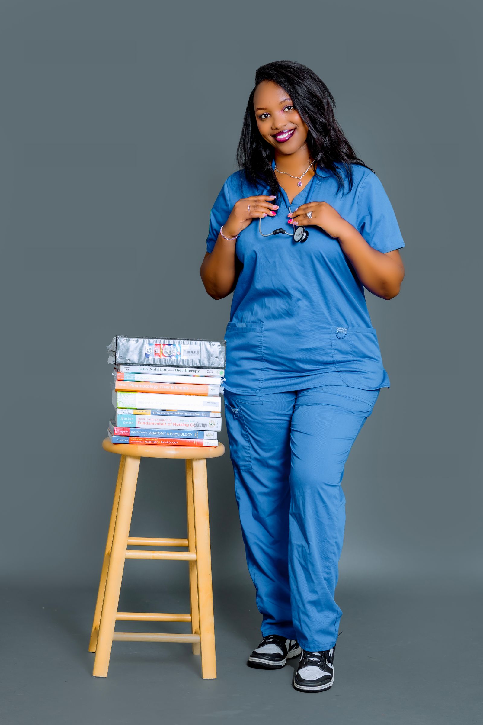 Smiling healthcare student holding books, planning UK studies