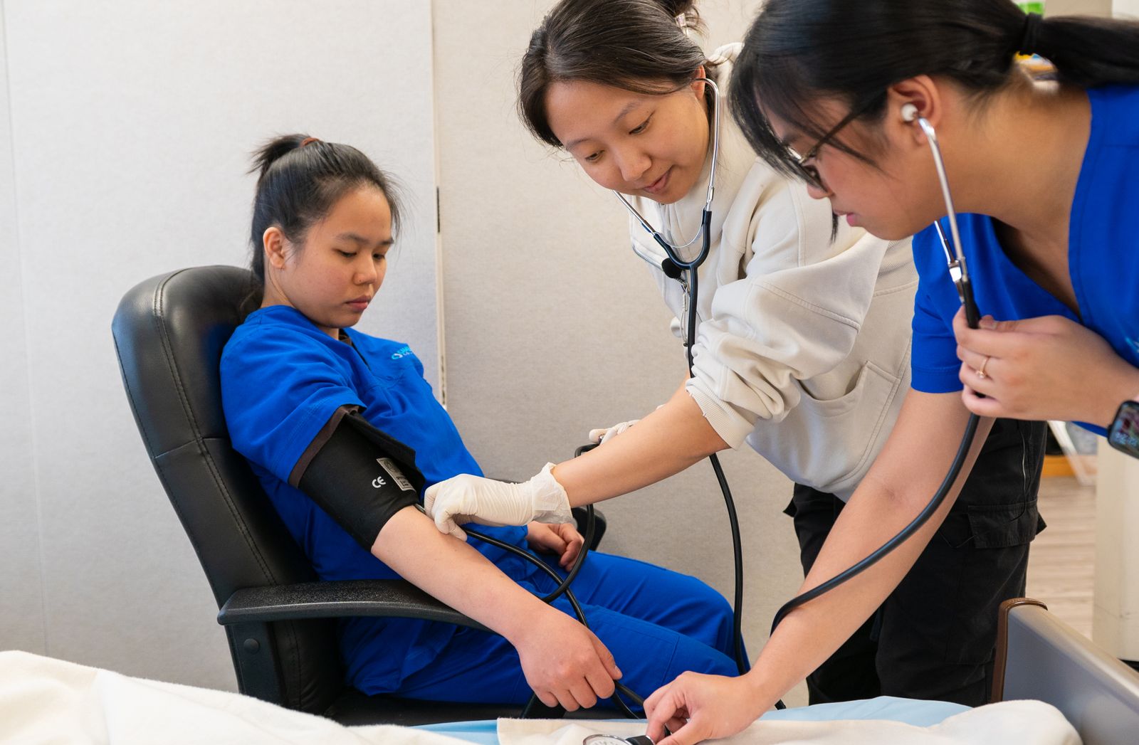 Health workers checking a patient’s blood pressure in a community clinic
